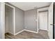 Bedroom features a closet with gray walls and light trim and wood-look floors at 6403 N Lois Ave, Tampa, FL 33614