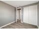 Bedroom featuring wood-look flooring and double closet doors at 6403 N Lois Ave, Tampa, FL 33614
