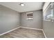 Bedroom features two windows with gray walls and light trim and wood-look floors at 6403 N Lois Ave, Tampa, FL 33614