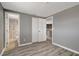 Bedroom features a view of the bathroom and closet with gray walls and wood-look floors at 6403 N Lois Ave, Tampa, FL 33614