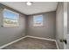 Cozy bedroom with two sunny windows and modern wood-look flooring at 6403 N Lois Ave, Tampa, FL 33614