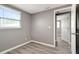 Bedroom with light wood-look floors and a sunny window at 6403 N Lois Ave, Tampa, FL 33614