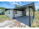 Exterior shot features the carport area of a cozy one-story home, great for shaded parking at 6403 N Lois Ave, Tampa, FL 33614