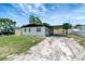 Cozy single-story home with a convenient carport, showcasing its simple architectural style at 6403 N Lois Ave, Tampa, FL 33614