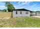 A single-story home featuring a well-maintained lawn and a carport with ample parking space at 6403 N Lois Ave, Tampa, FL 33614