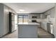 Modern kitchen featuring an island, stainless steel appliances and stylish gray cabinetry at 6403 N Lois Ave, Tampa, FL 33614