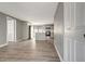 Open-concept living room and kitchen features sleek, modern flooring and stylish gray walls at 6403 N Lois Ave, Tampa, FL 33614