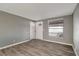 Comfortable living room showcasing modern flooring and neutral gray walls throughout the home at 6403 N Lois Ave, Tampa, FL 33614