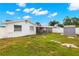 A well-maintained backyard featuring a screened-in porch and storage shed, offering a relaxing and practical outdoor space at 6433 Reef Cir, Tampa, FL 33625