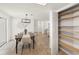 Open-concept dining area with modern light fixture and convenient closet access to the living area at 6433 Reef Cir, Tampa, FL 33625