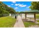 A fenced dog park entrance with signage and greenery, creating a safe and welcoming space for pets and owners at 6433 Reef Cir, Tampa, FL 33625