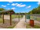 Gated entrance to a dog park with signage, providing a secure and enjoyable area for canine companions and their owners at 6433 Reef Cir, Tampa, FL 33625