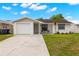 Charming single-story home featuring a well-manicured lawn and a welcoming front porch at 6433 Reef Cir, Tampa, FL 33625