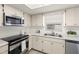 Well-maintained kitchen with stainless steel appliances and white cabinetry at 6433 Reef Cir, Tampa, FL 33625
