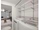 Laundry area with washer, dryer, wire shelving, and access to a living room at 6433 Reef Cir, Tampa, FL 33625