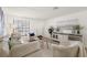 Bright living room with neutral decor, tile flooring, and natural light at 6433 Reef Cir, Tampa, FL 33625