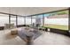 Enclosed sunroom with tile flooring, modern furniture, and outdoor views at 6433 Reef Cir, Tampa, FL 33625