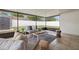 Enclosed sunroom with tile flooring, modern furniture, and outdoor views at 6433 Reef Cir, Tampa, FL 33625