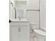 This bathroom features a white vanity with gold hardware, toilet and a shower with subway tile at 7304 Donnybrook Ln, Sarasota, FL 34240