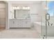 Bright bathroom features double vanity, large mirror, soaking tub, glass shower and tile floors at 7304 Donnybrook Ln, Sarasota, FL 34240