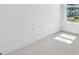Bright bedroom corner showing the natural light from the window and carpet flooring at 7304 Donnybrook Ln, Sarasota, FL 34240