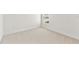 Empty bedroom featuring neutral carpet, white trim and walls, and double electrical outlets at 7304 Donnybrook Ln, Sarasota, FL 34240