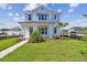 Charming two-story home with a well-manicured lawn and inviting walkway at 7304 Donnybrook Ln, Sarasota, FL 34240