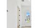 Bright hallway with white walls, white trim and a view of the front yard at 7304 Donnybrook Ln, Sarasota, FL 34240