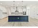 Modern kitchen with a large island, stainless steel appliances, and white cabinetry at 7304 Donnybrook Ln, Sarasota, FL 34240