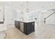 Spacious kitchen with center island, stainless steel appliances, and a view of the open-concept living area at 7304 Donnybrook Ln, Sarasota, FL 34240