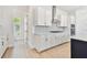 Well-lit kitchen featuring sleek white cabinets, stainless steel appliances, and stylish backsplash at 7304 Donnybrook Ln, Sarasota, FL 34240
