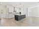 Bright, modern kitchen with a large island, stainless steel appliances, and stylish pendant lighting at 7304 Donnybrook Ln, Sarasota, FL 34240