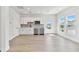 Modern kitchenette features stainless appliances, white cabinetry and a window and door to the exterior at 7304 Donnybrook Ln, Sarasota, FL 34240
