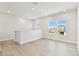 Bright living area with plank flooring, recessed lights and several windows with neighborhood views at 7304 Donnybrook Ln, Sarasota, FL 34240
