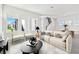 Bright, open living room with modern furnishings, large windows, and a view of the staircase at 7304 Donnybrook Ln, Sarasota, FL 34240