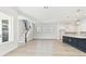 Open-concept living space with staircase, light wood floors, and abundant natural light from windows at 7304 Donnybrook Ln, Sarasota, FL 34240