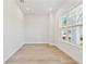 Bright and airy office space with light wood floors and a large window at 7304 Donnybrook Ln, Sarasota, FL 34240