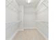 Spacious walk-in closet with carpeted floor and wire shelving for optimal storage space at 7304 Donnybrook Ln, Sarasota, FL 34240