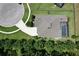 Aerial view of a home with a private pool, well-manicured yard, and a long driveway, all surrounded by lush greenery at 8016 Rock Spring Ct, Land O Lakes, FL 34638