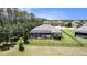 Aerial view of home with a screened pool, well-maintained lawn, and fenced-in backyard surrounded by trees at 8016 Rock Spring Ct, Land O Lakes, FL 34638