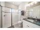 Modern bathroom featuring a glass enclosed shower, granite countertop, and decorative wall accents at 8016 Rock Spring Ct, Land O Lakes, FL 34638