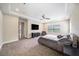 Large carpeted bedroom with TV, ceiling fan, and ample natural light from the windows at 8016 Rock Spring Ct, Land O Lakes, FL 34638