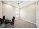 A simple bedroom features carpeting and a window for natural light, alongside a modern desk at 8016 Rock Spring Ct, Land O Lakes, FL 34638
