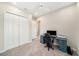 A versatile bedroom features a neutral color scheme, closet space and an office setup with a modern desk at 8016 Rock Spring Ct, Land O Lakes, FL 34638