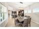 A dining room features a wooden table and chairs, with a view of the kitchen at 8016 Rock Spring Ct, Land O Lakes, FL 34638