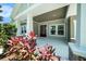 Inviting front porch with stone accents, decorative plants, and a stylish front door, offering a warm welcome at 8016 Rock Spring Ct, Land O Lakes, FL 34638