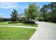 Well-manicured front yard with lush green lawn, landscaping, and a charming two-story home at 8016 Rock Spring Ct, Land O Lakes, FL 34638