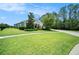 Beautifully landscaped front yard leading to a single-story home with a spacious driveway at 8016 Rock Spring Ct, Land O Lakes, FL 34638