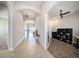 An inviting hallway showcases archways, tile flooring, and views of the living room and an office at 8016 Rock Spring Ct, Land O Lakes, FL 34638