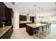 Modern kitchen featuring an island with bar seating, stainless steel appliances, and dark wood cabinetry, great for gatherings at 8016 Rock Spring Ct, Land O Lakes, FL 34638